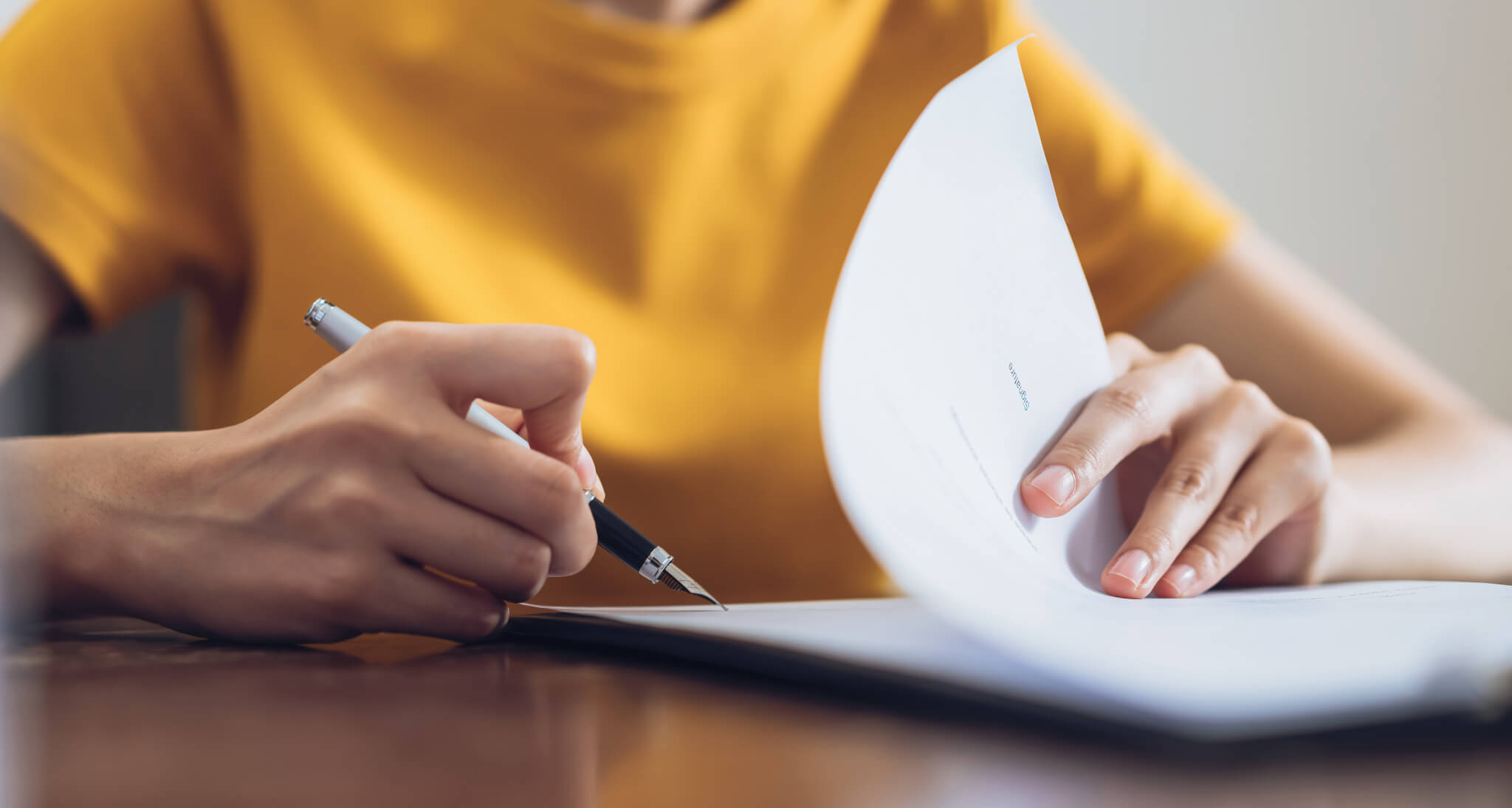 Woman signing document