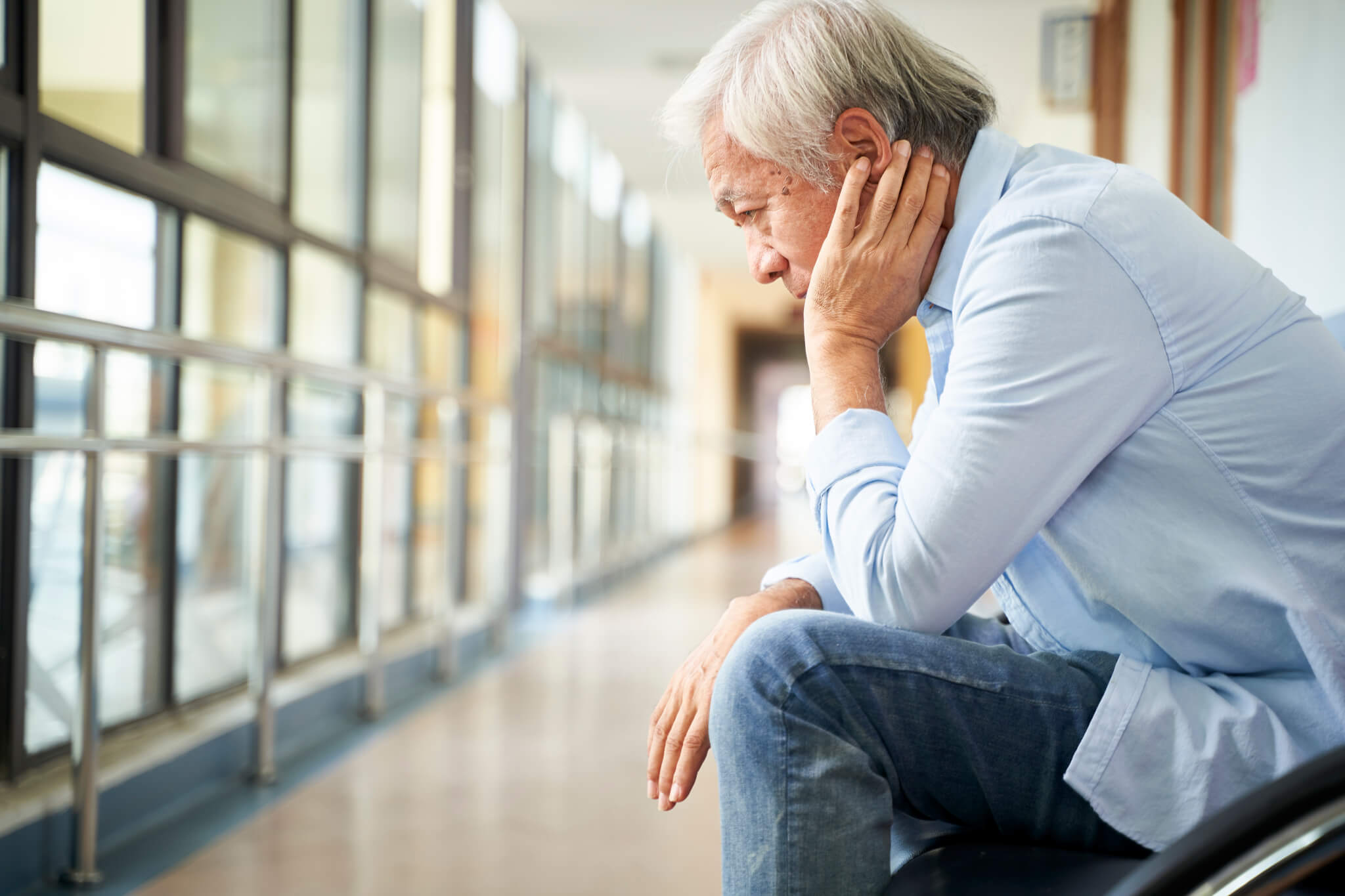 asian old man devastated by bad news