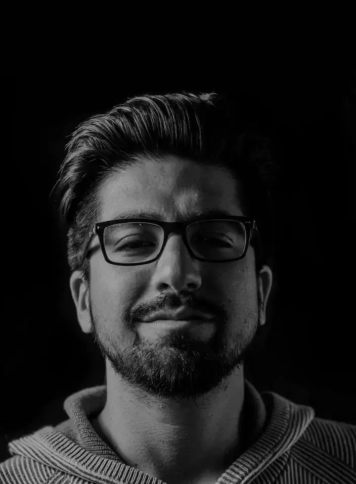 A man with glasses and a beard, dressed in a hoodie, smiles as a client of Osbornes Law solicitors. This image is specifically for mobile devices.