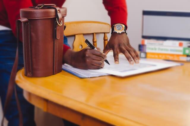 man signing paperwork