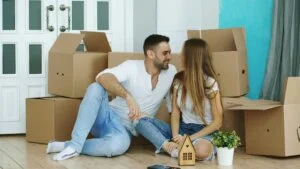 Couple unpacking moving boxes in their new home